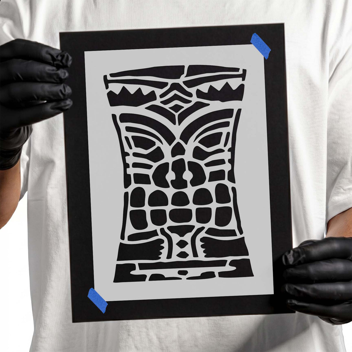 Tiki face stencil with curved eyes, block teeth, and geometric markings
