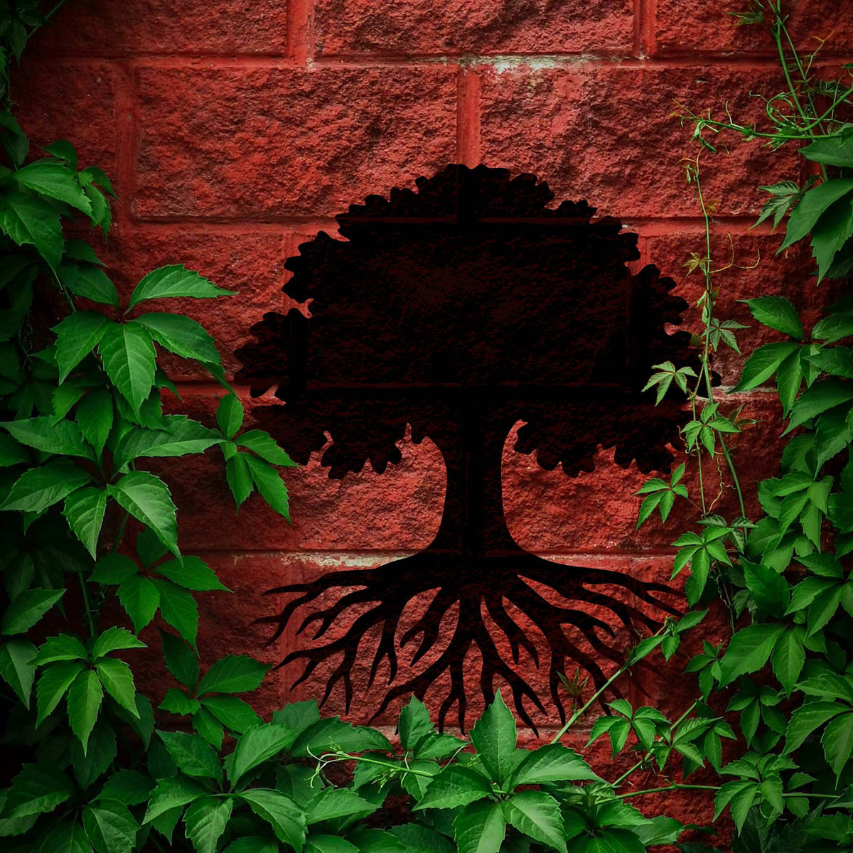 Bold tree roots stencil spreading beneath a leafy canopy on red brick