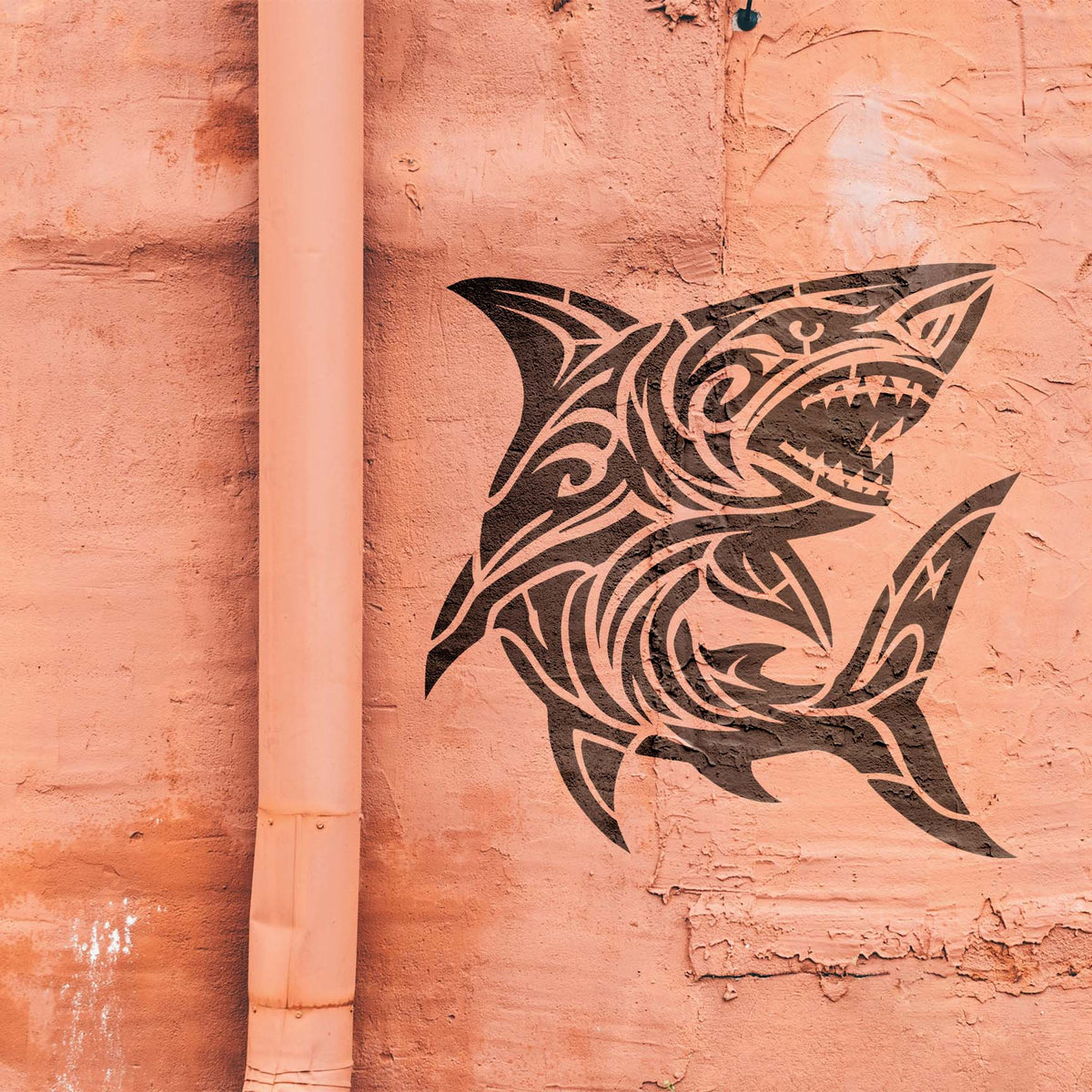 Intricate Tribal Great White Shark Stencil painted black on a textured salmon exterior wall