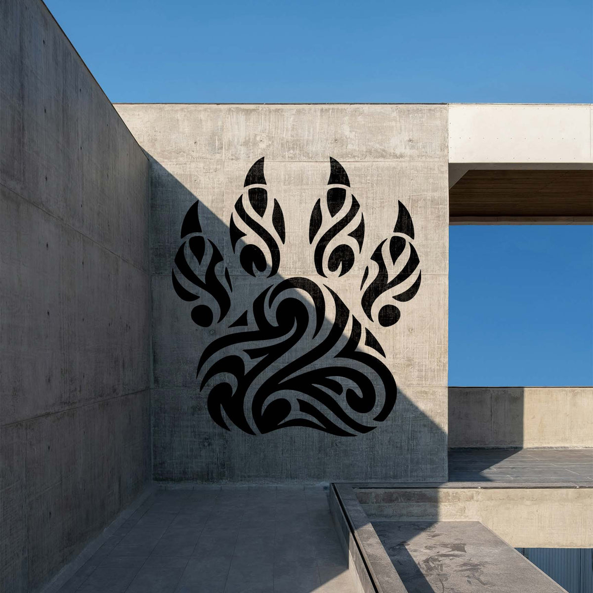 Tribal Paw Print Stencil painted black on a modern concrete wall
