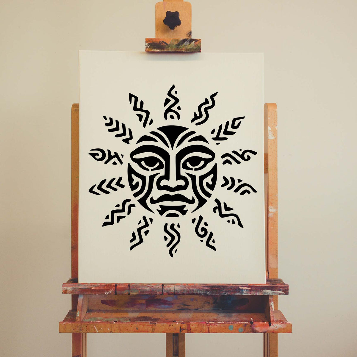 Bold Tribal Sun Face Stencil artwork stands out on a white canvas displayed on an easel