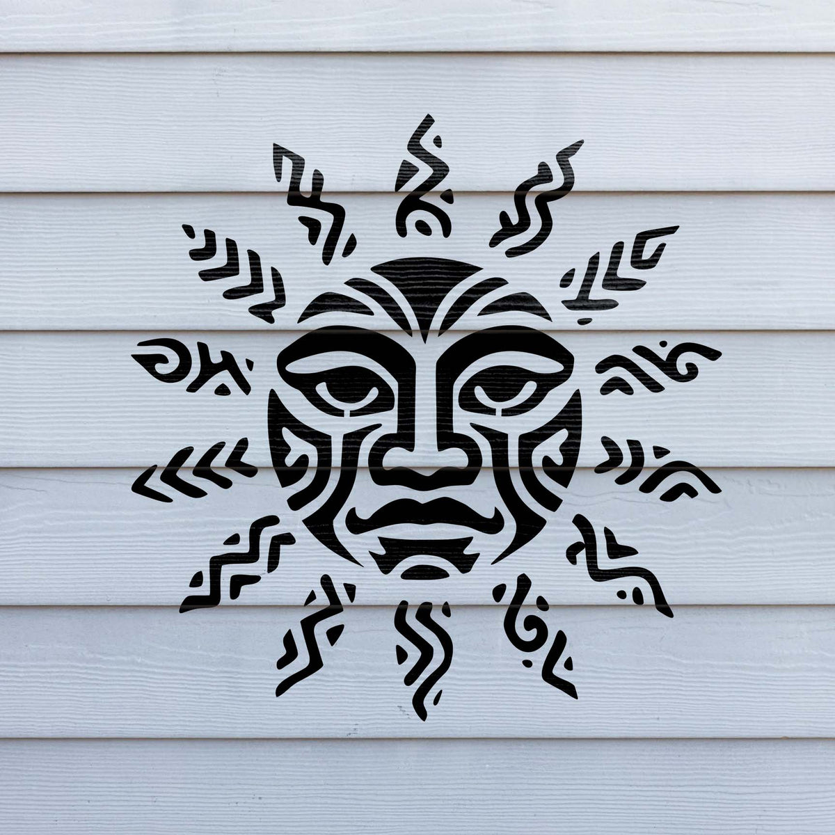 Against white siding, the Tribal Sun Face Stencil reveals a striking face with tribal rays