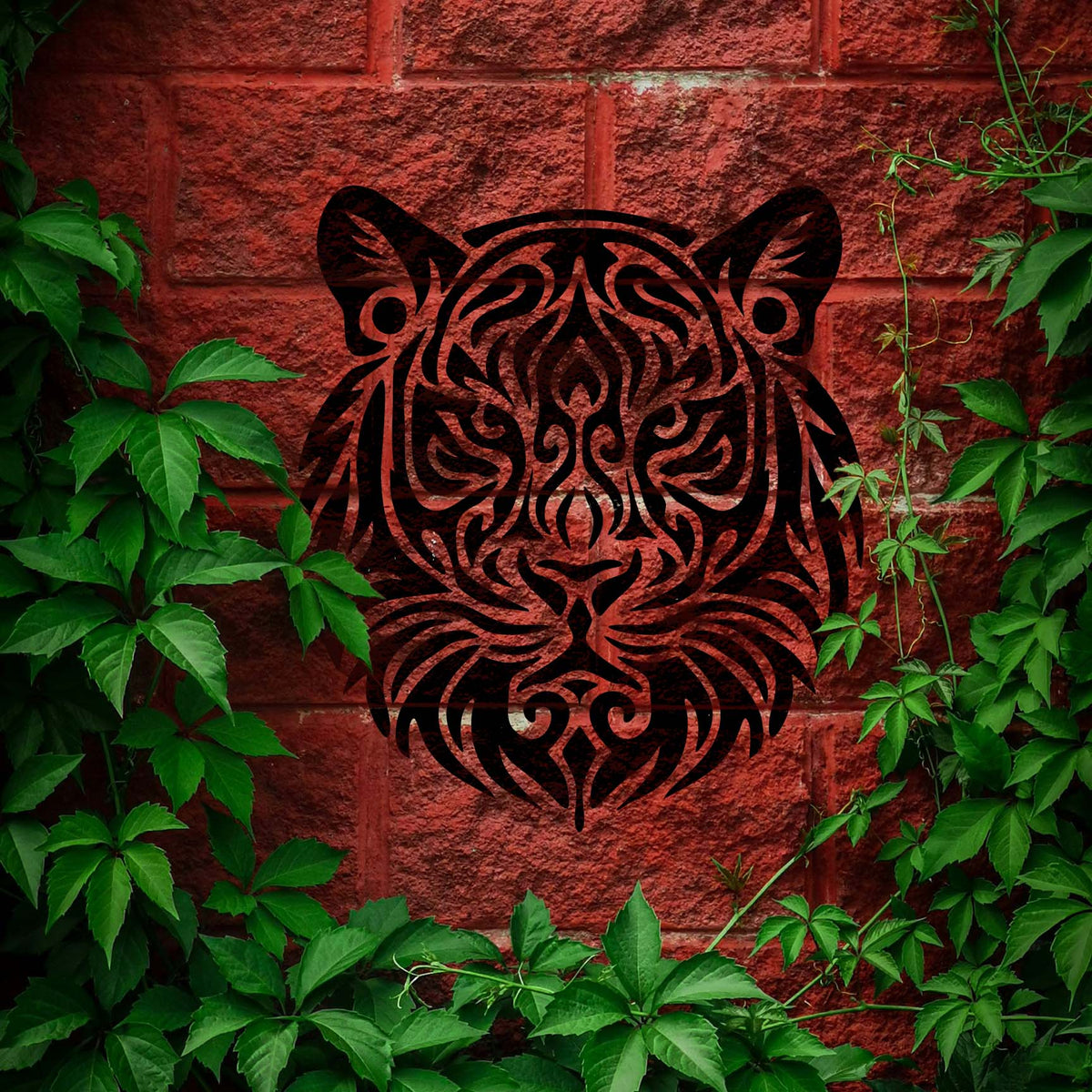 Framed by green ivy, the Tribal Tiger Head Stencil stands boldly on a red brick wall