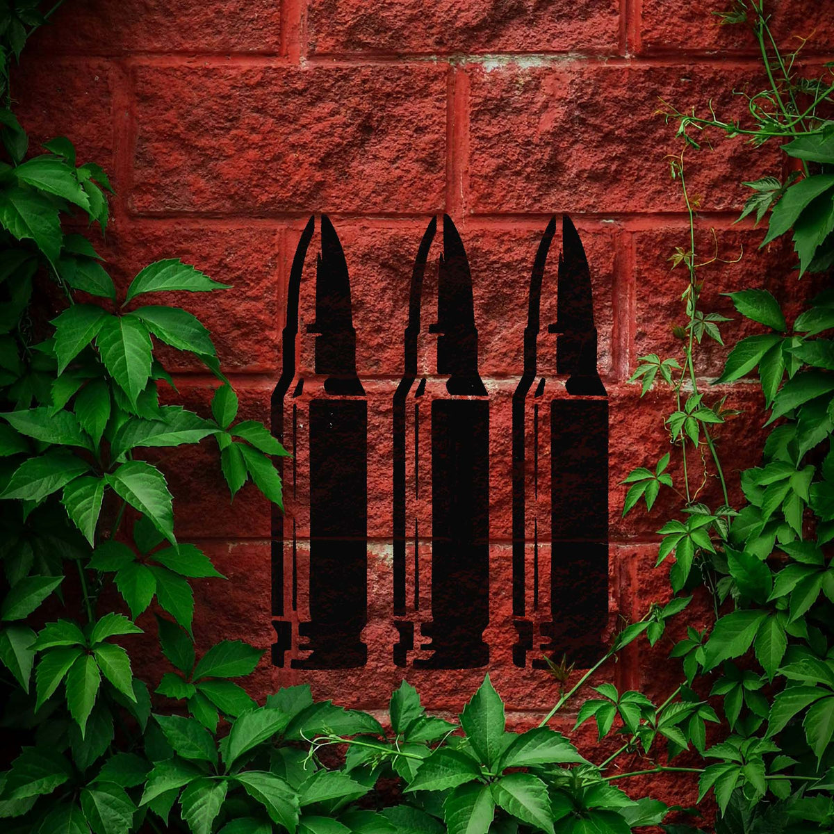 Triple Rifle Cartridge stencil forms three bold rounds against vine-covered red brick