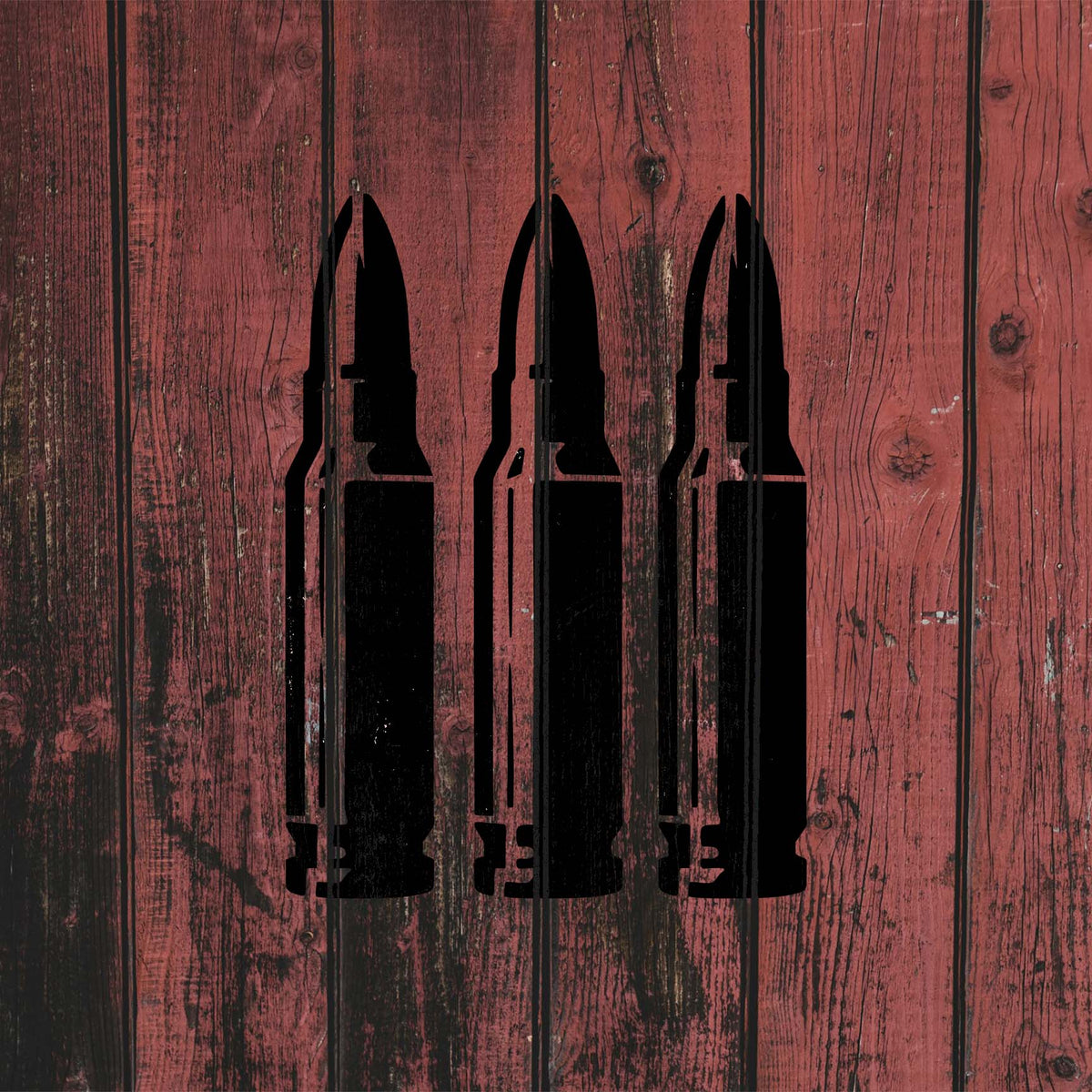 Triple Rifle Cartridge stencil creates a striking black trio on weathered red wood