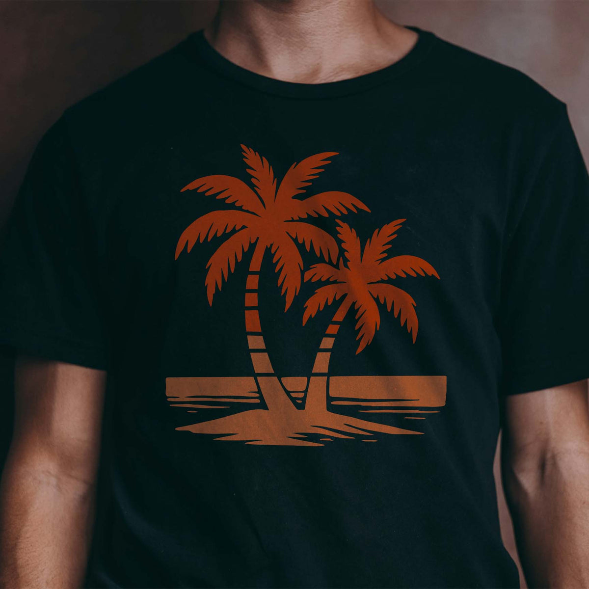 Sunset-toned tropical palm beach stencil printed boldly across a black shirt