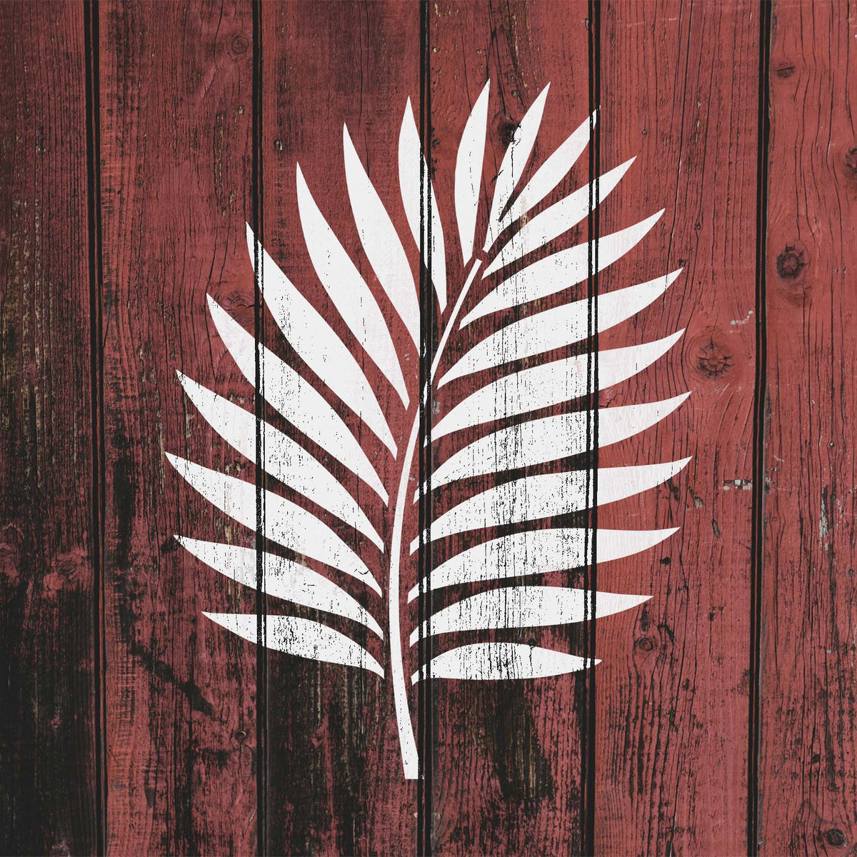 Crisp white tropical palm frond stencil sweeping across weathered red wood