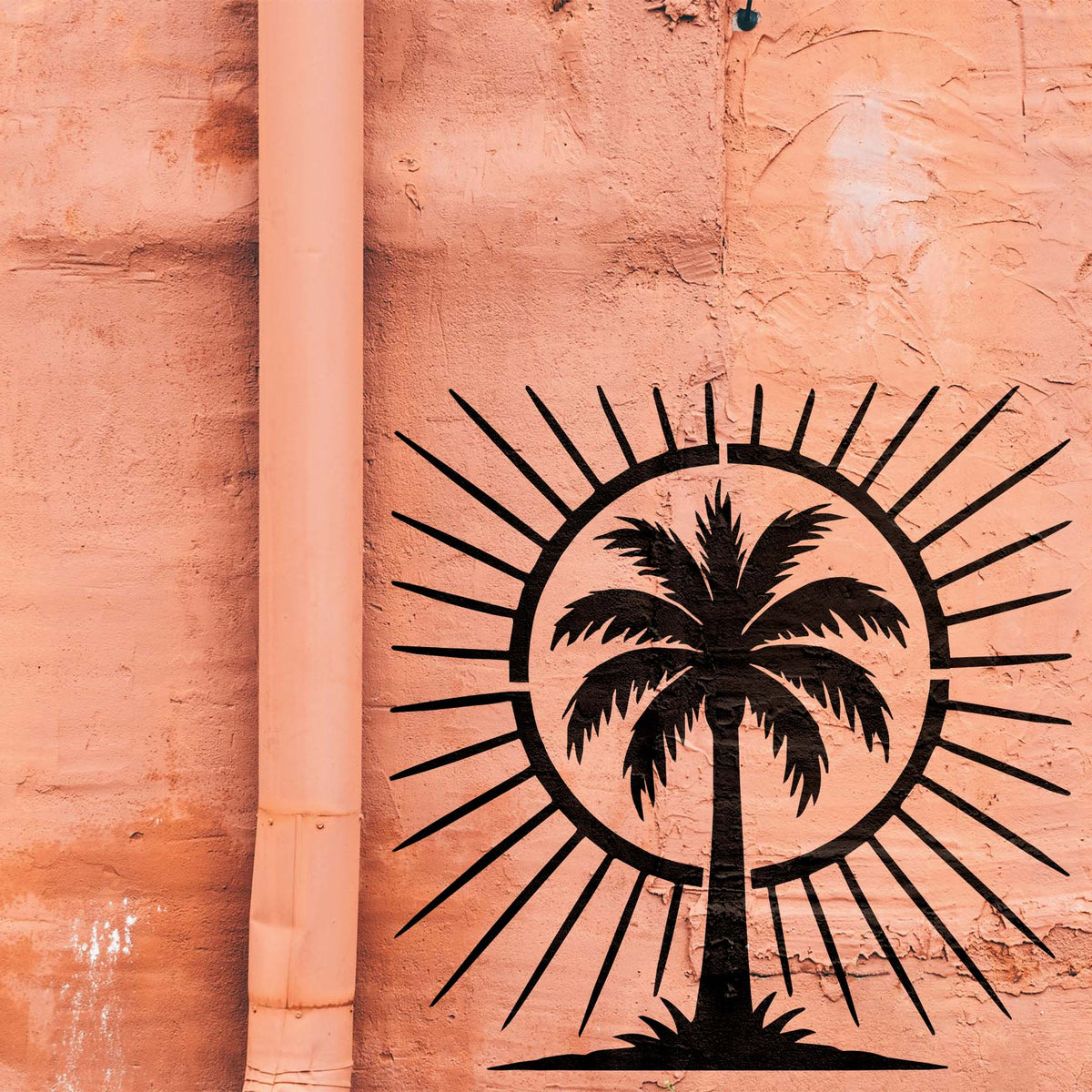 Tropical Palm Tree Sunburst Stencil painted black across a textured peach wall