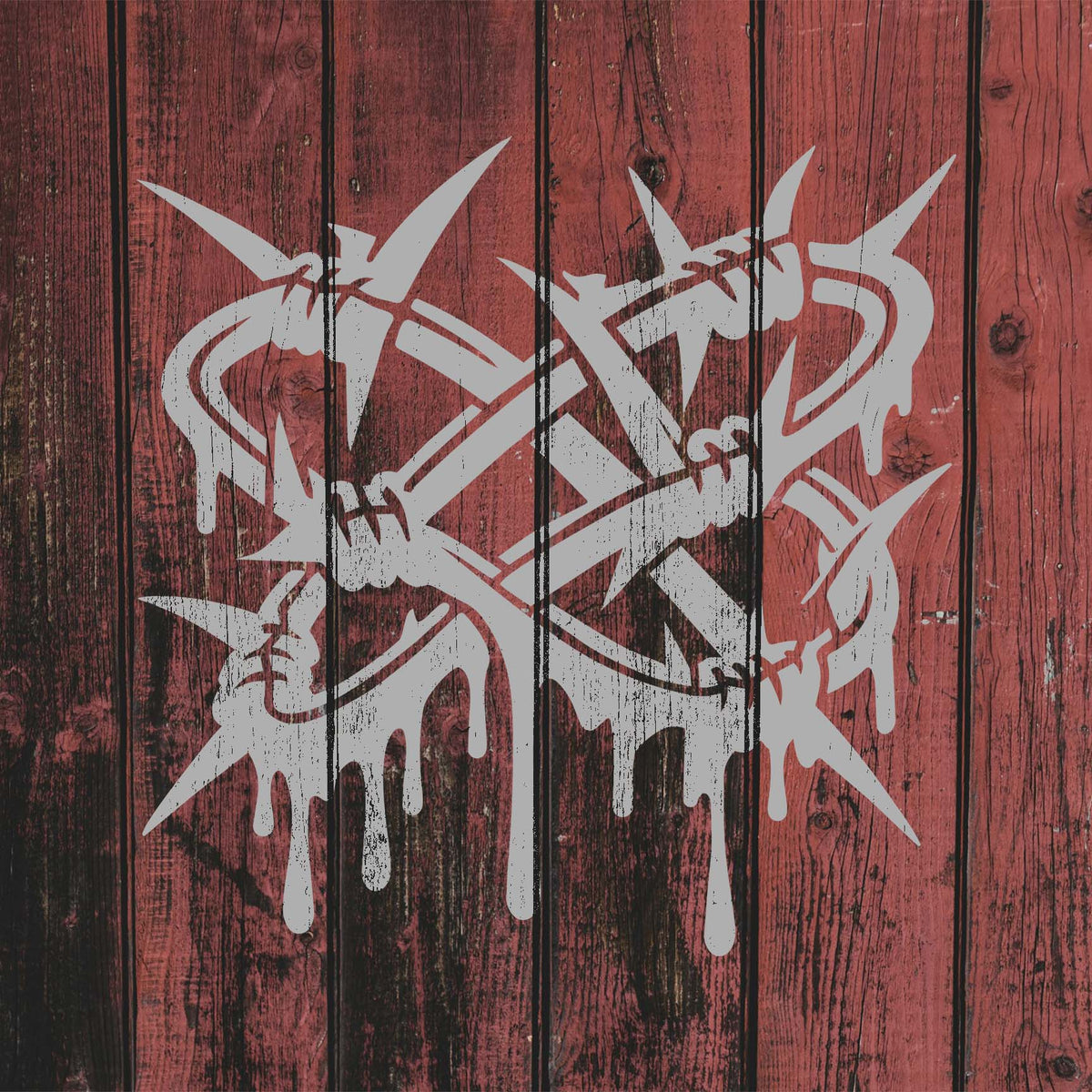 Against weathered red wood, the Twisted Barbed Wire Stencil reveals silver spikes and bold graffiti drips.