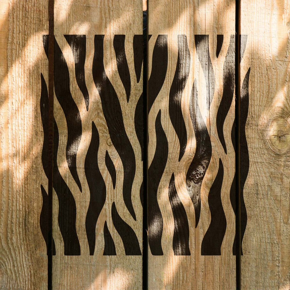 Sunlit wood planks display the Vertical Tiger Stripe Pattern Stencil with flowing black stripes