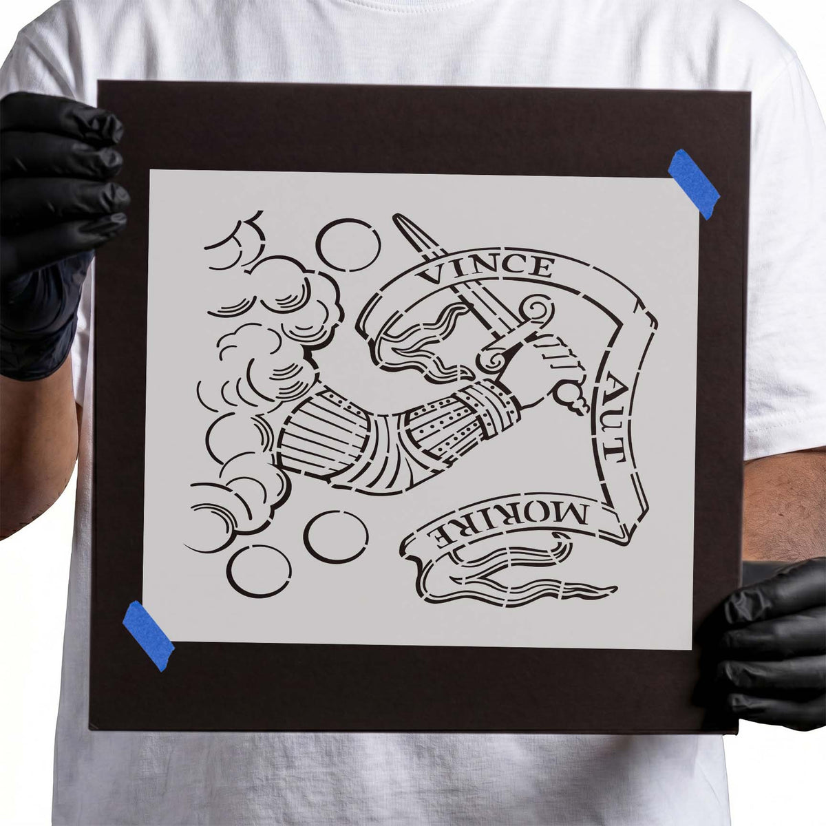 Heraldic stencil with armored arm, sword, clouds, and Latin motto banner