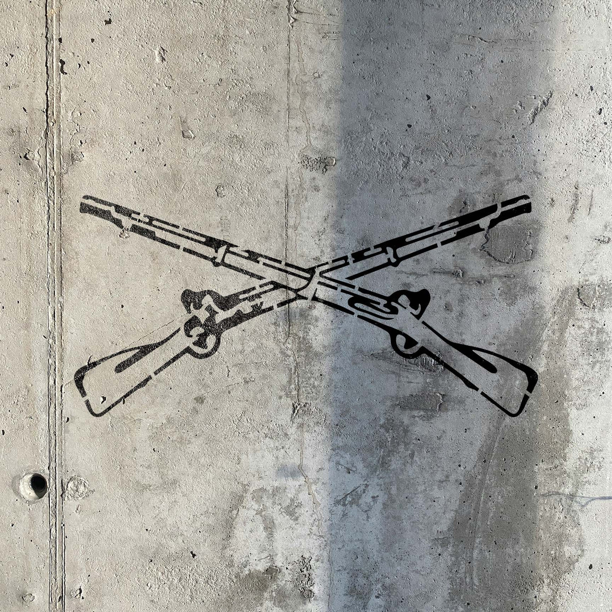 Vintage Crossed Rifle stencil displays detailed antique firearms across weathered concrete