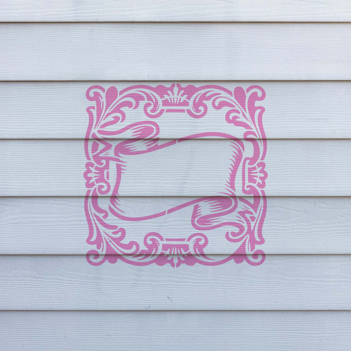 Vintage Scroll Banner Frame stencil appears in soft pink across white exterior siding