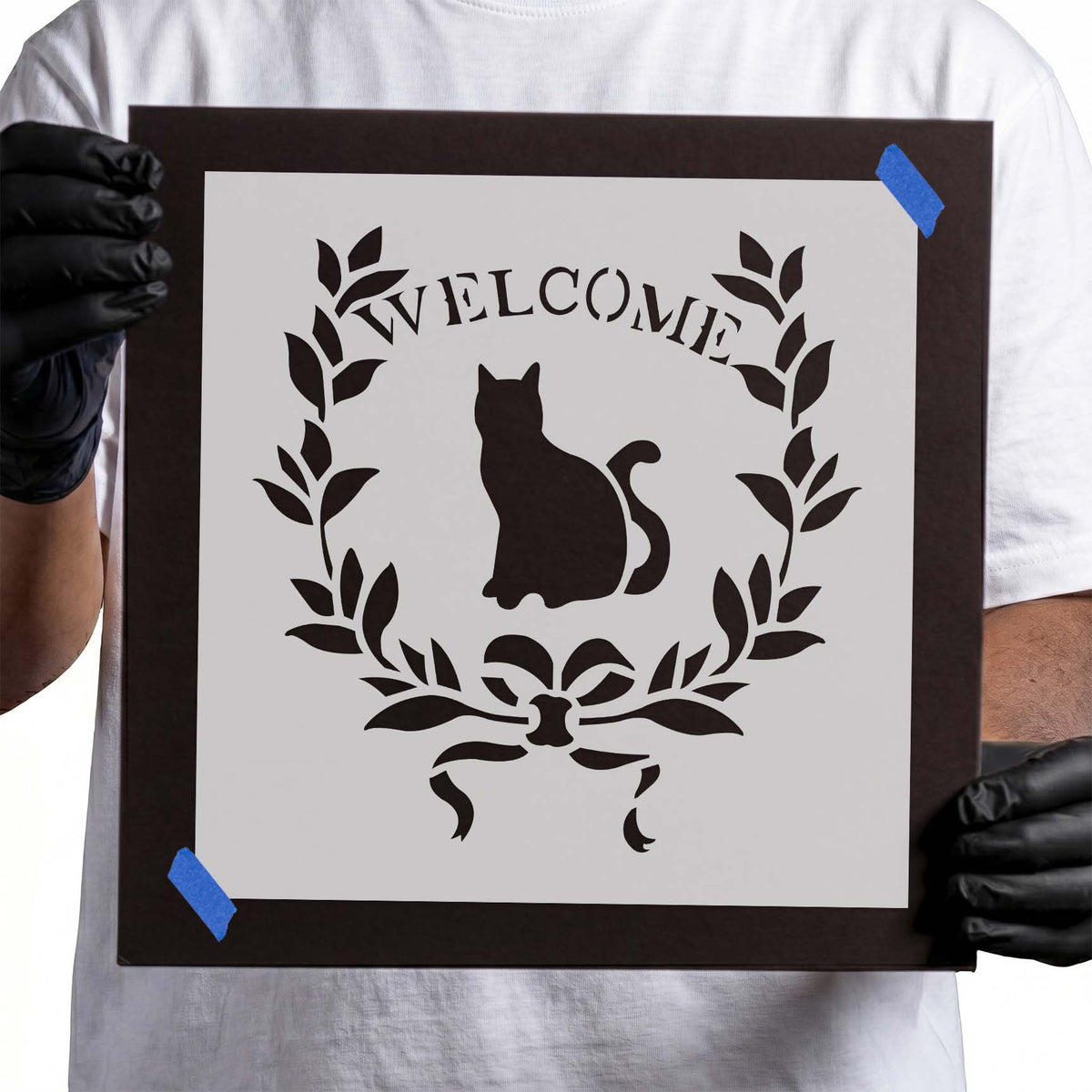 Welcome Wreath with Cat Stencil featuring a seated cat, leafy branches, and bow