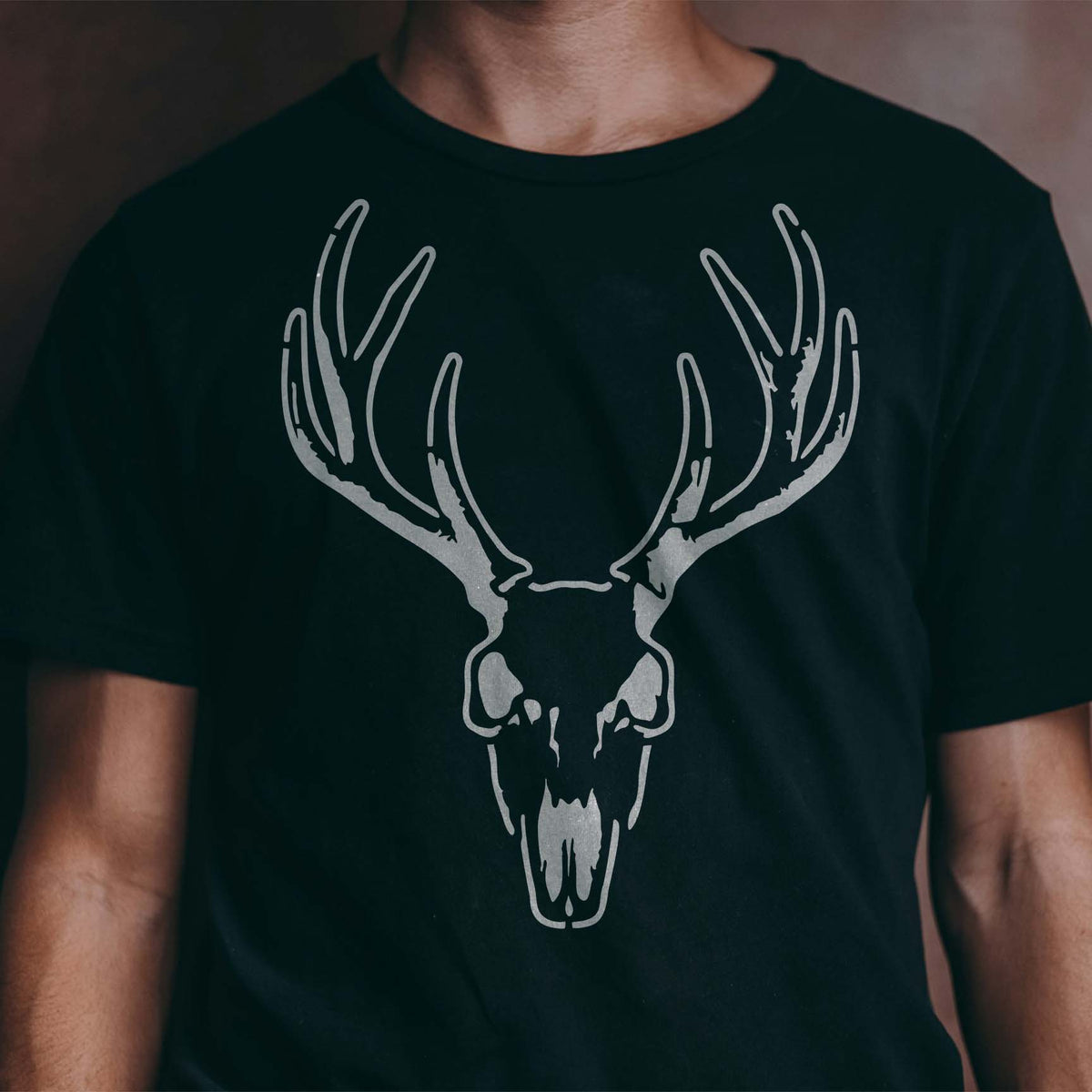 Whitetail Buck Skull Stencil stands out in silver with sweeping antlers on a black shirt
