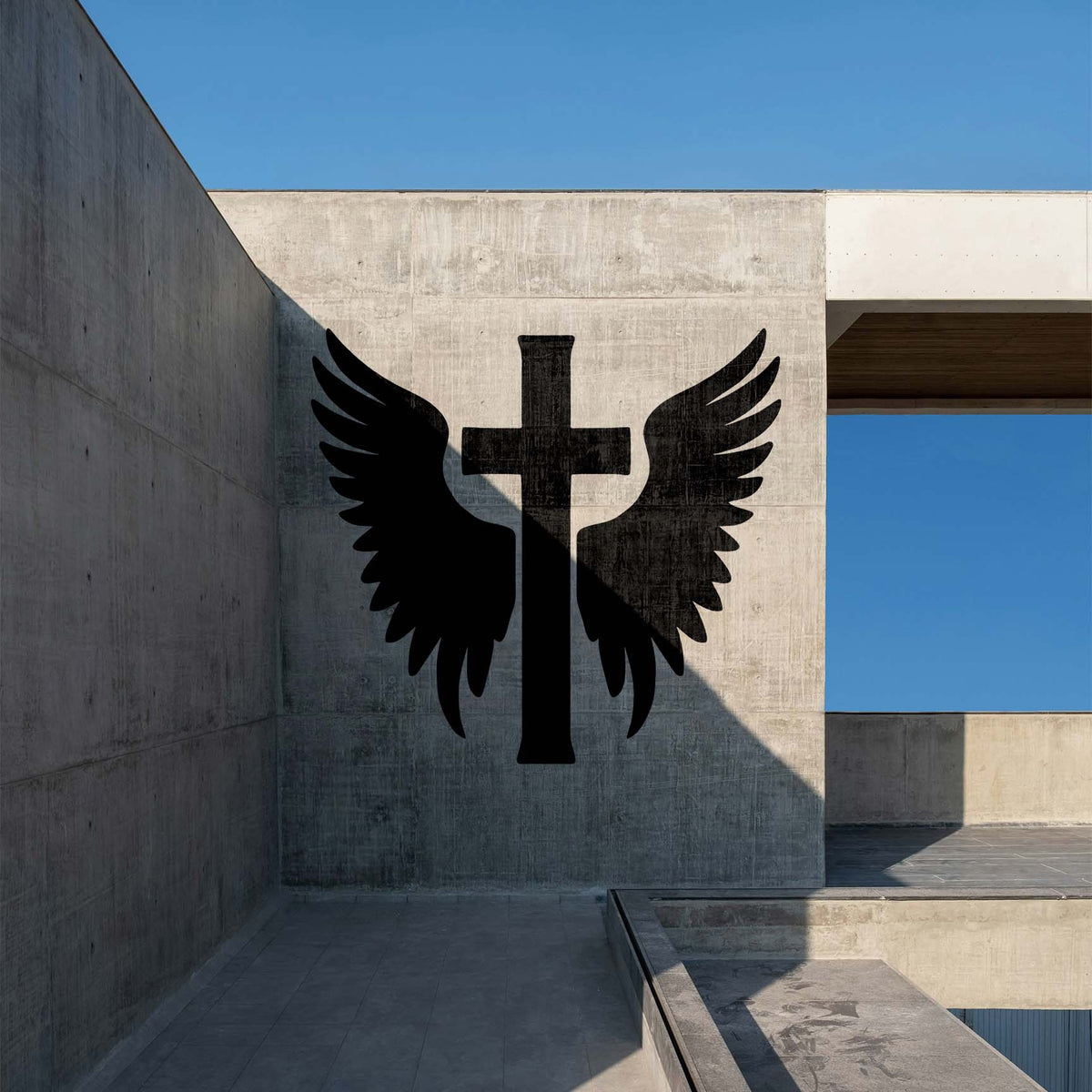Winged Christian Cross Stencil displayed large on a modern concrete wall beneath a clear blue sky