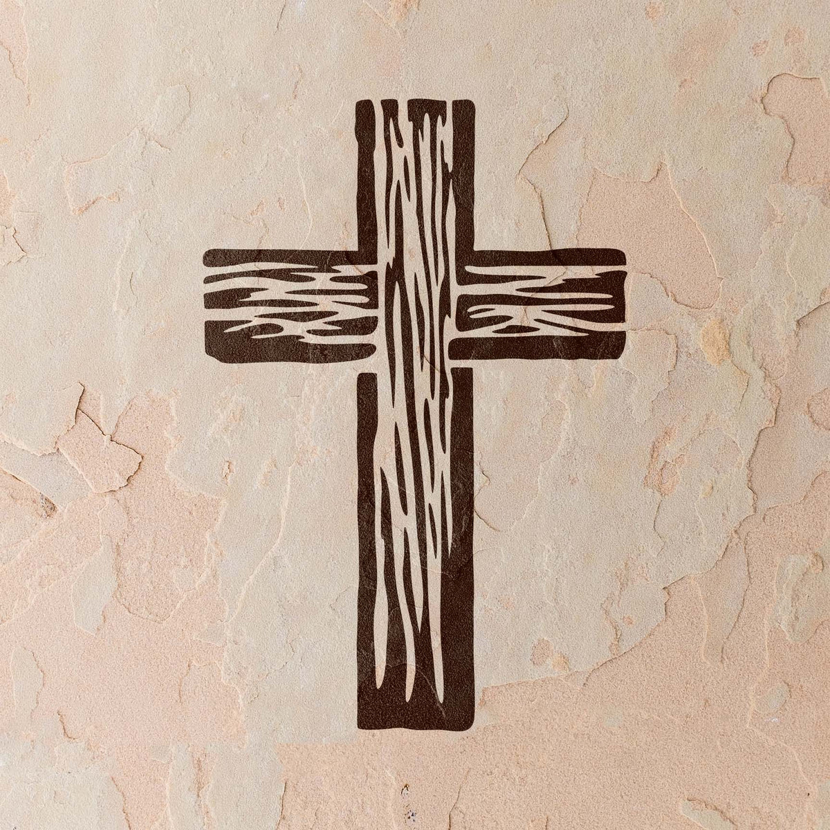 A Wooden Christian Cross Stencil stands out on a softly cracked stucco wall in warm neutral tones