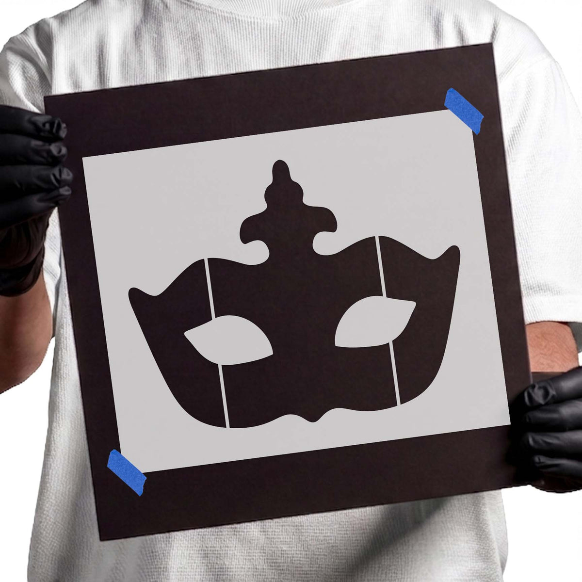 Masquerade mask stencil with curved silhouette and stylized eye openings