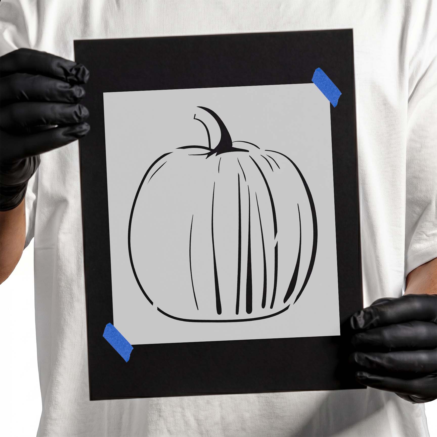 Person holding laser-cut Pumpkin Stencil