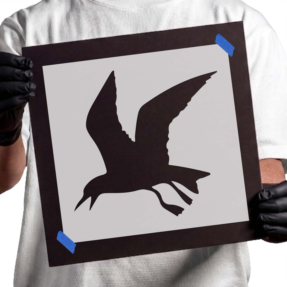 Flying seagull stencil with raised wings and extended legs