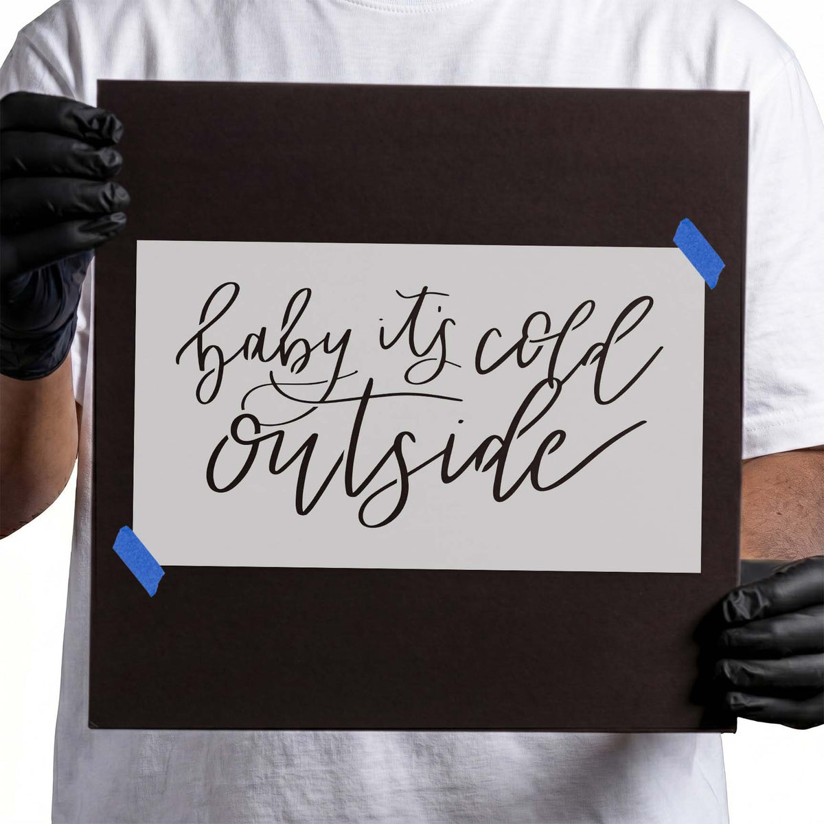 Baby It's Cold Outside Stencil featuring two lines of flowing cursive script and elegant flourishes