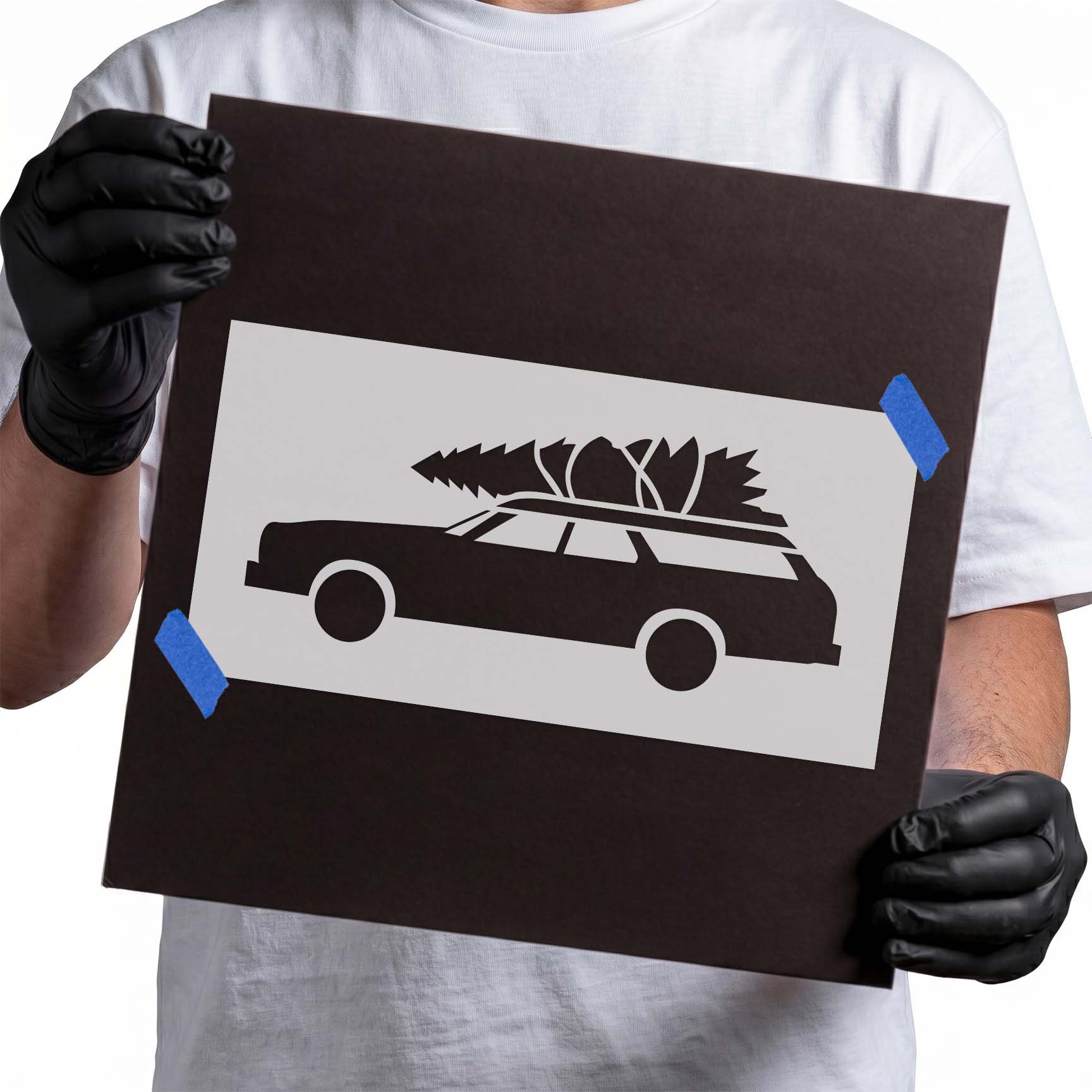 Car with Christmas tree stencil featuring a classic station wagon carrying a holiday tree on the roof