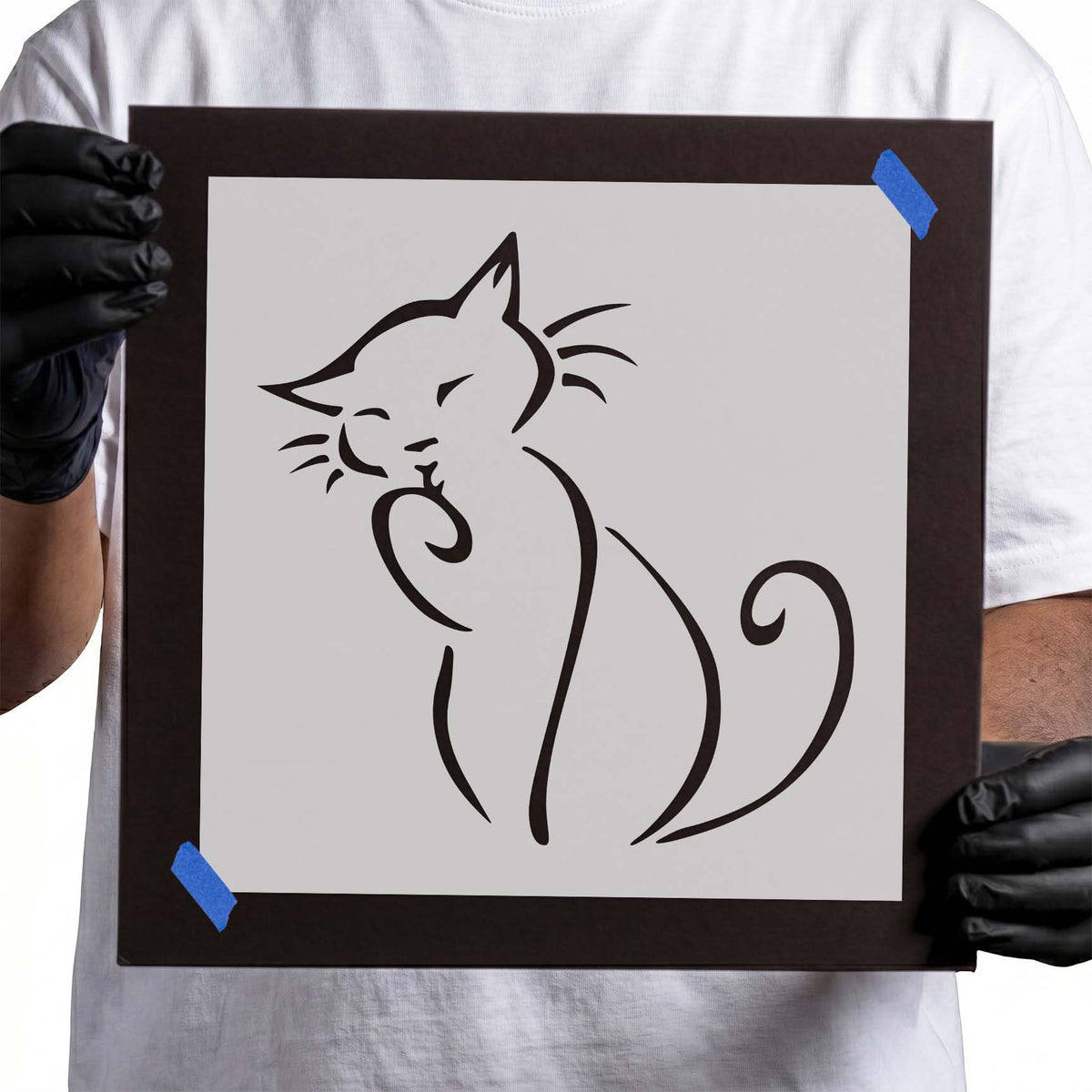 Seated cat stencil with whiskers, raised paw and curled tail