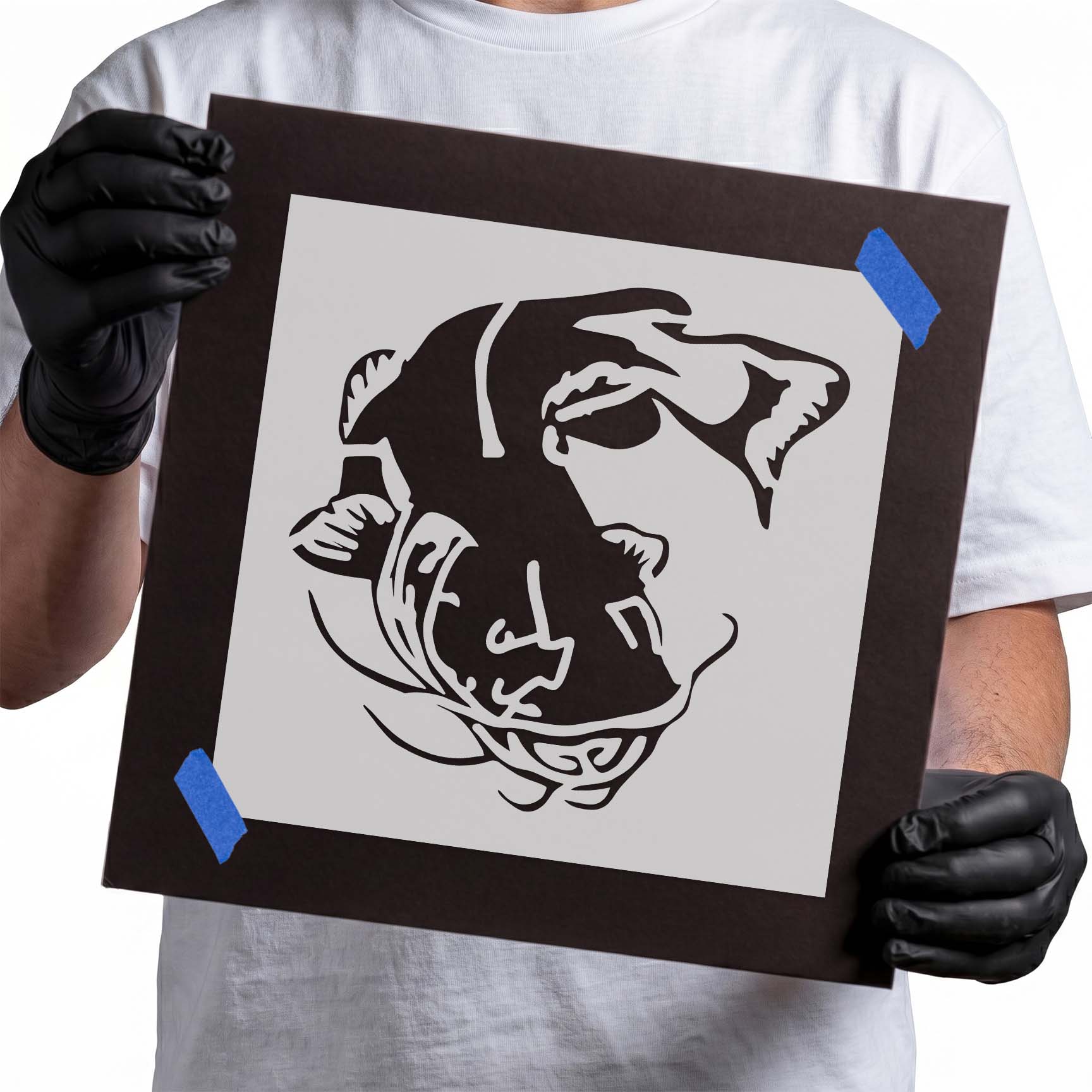 Person holding reusable catfish stencil with detailed fish illustration.