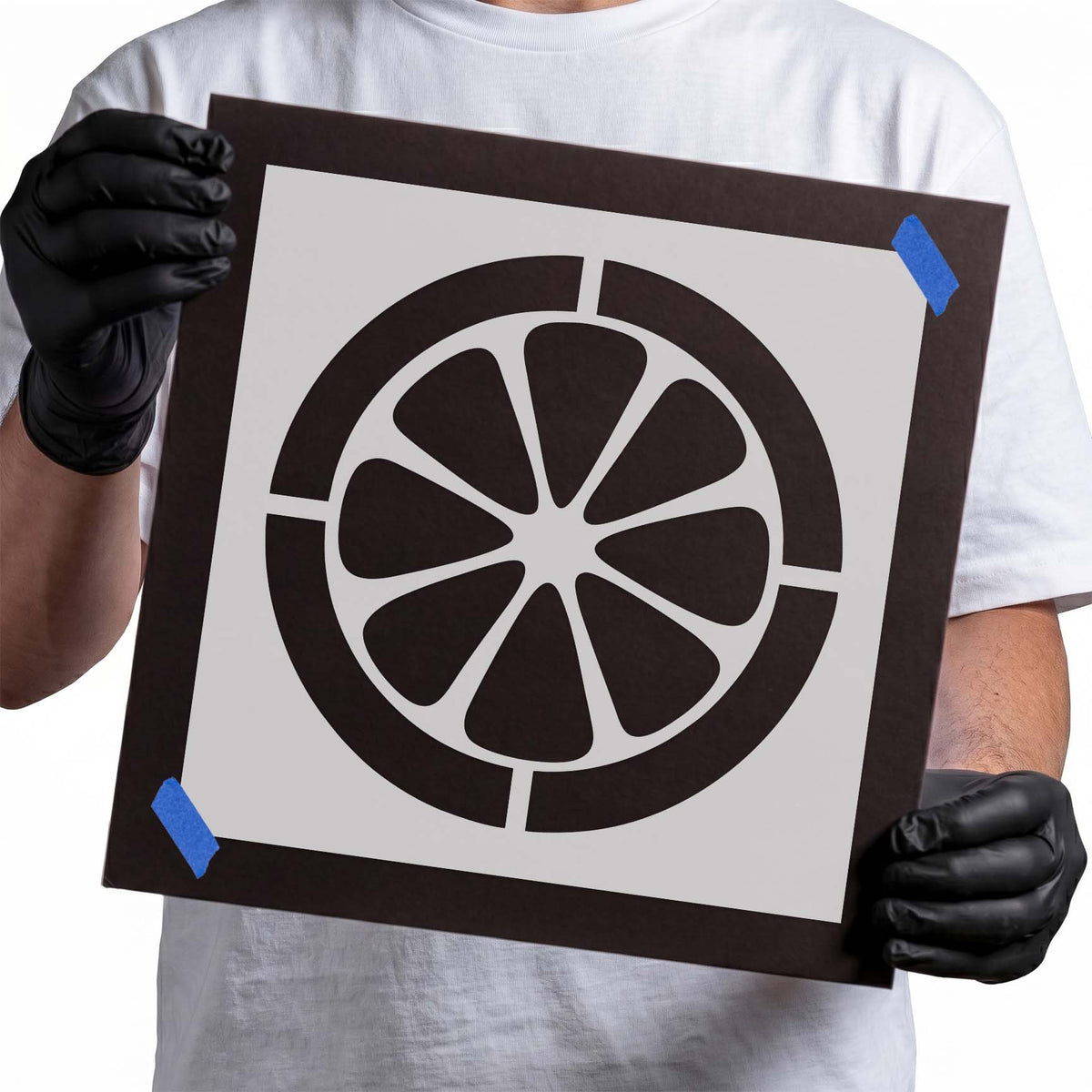 Citrus slice stencil with eight rounded fruit segments inside a thick circular rind