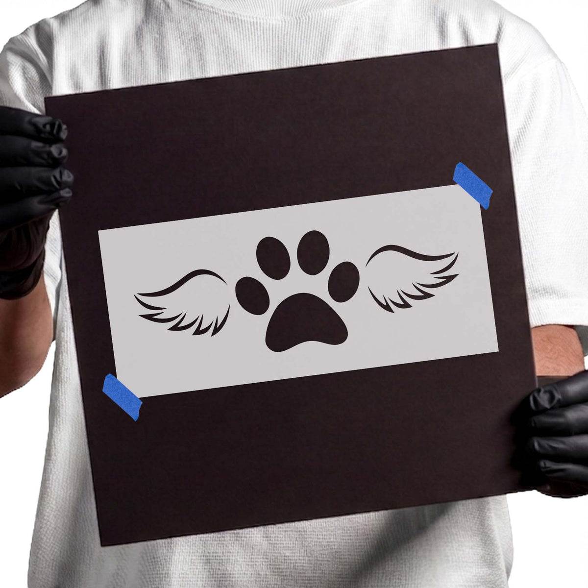 Winged dog paw stencil with central paw print and feathered wings