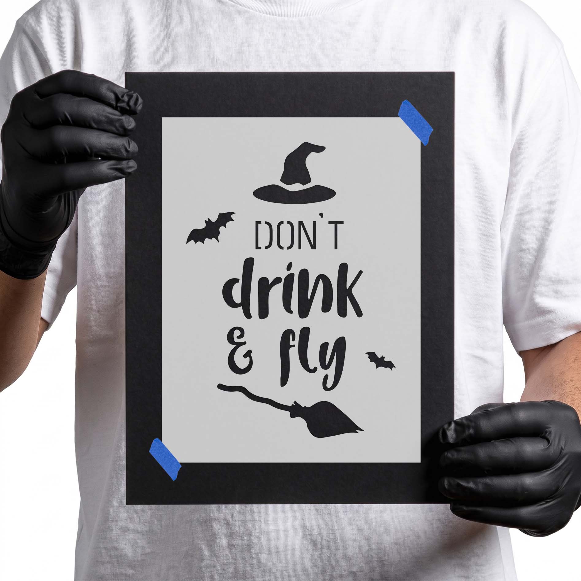 Person holding reusable Don't Drink & Fly Halloween Stencil