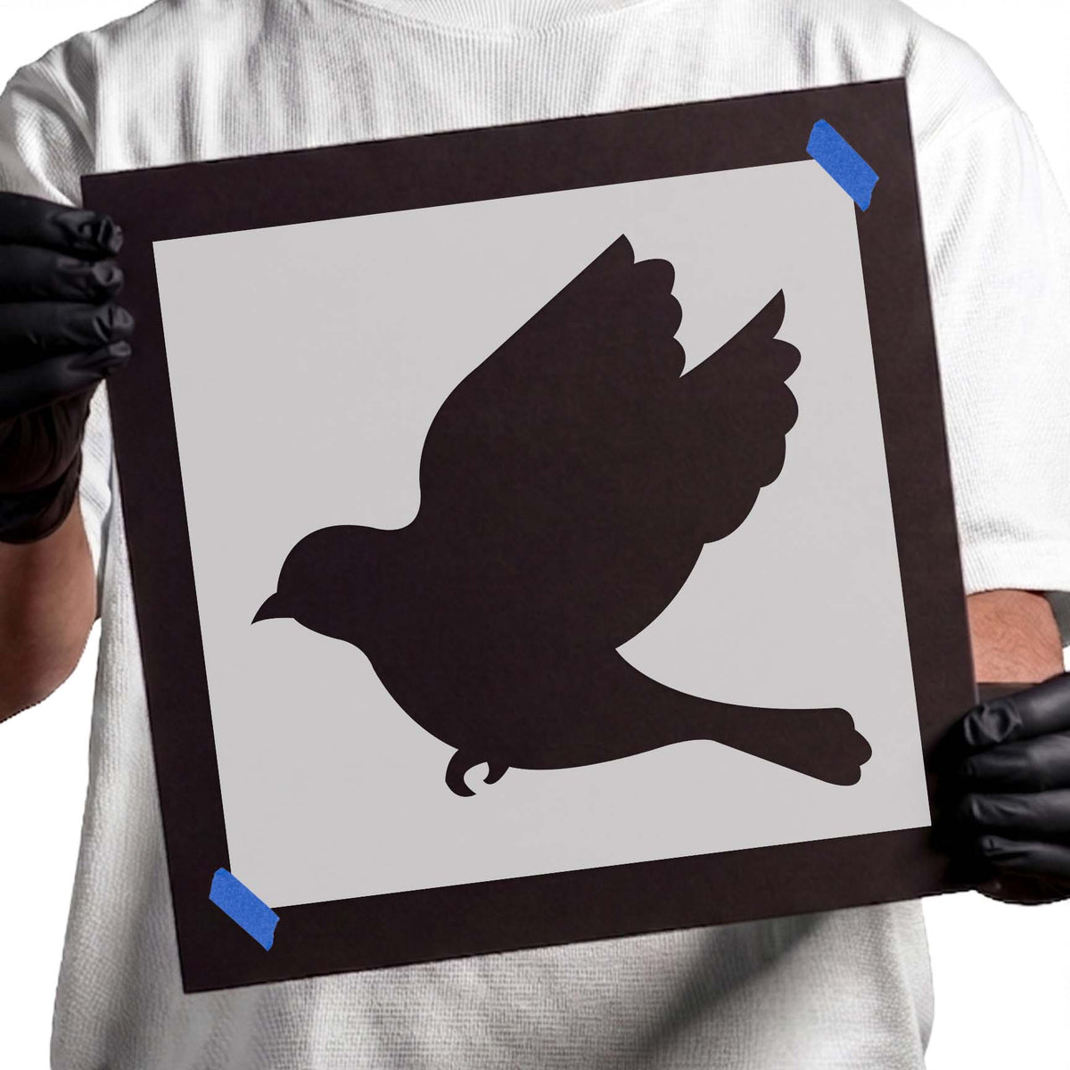 In flight, the Flying Dove Stencil shows raised wings and a long sweeping tail