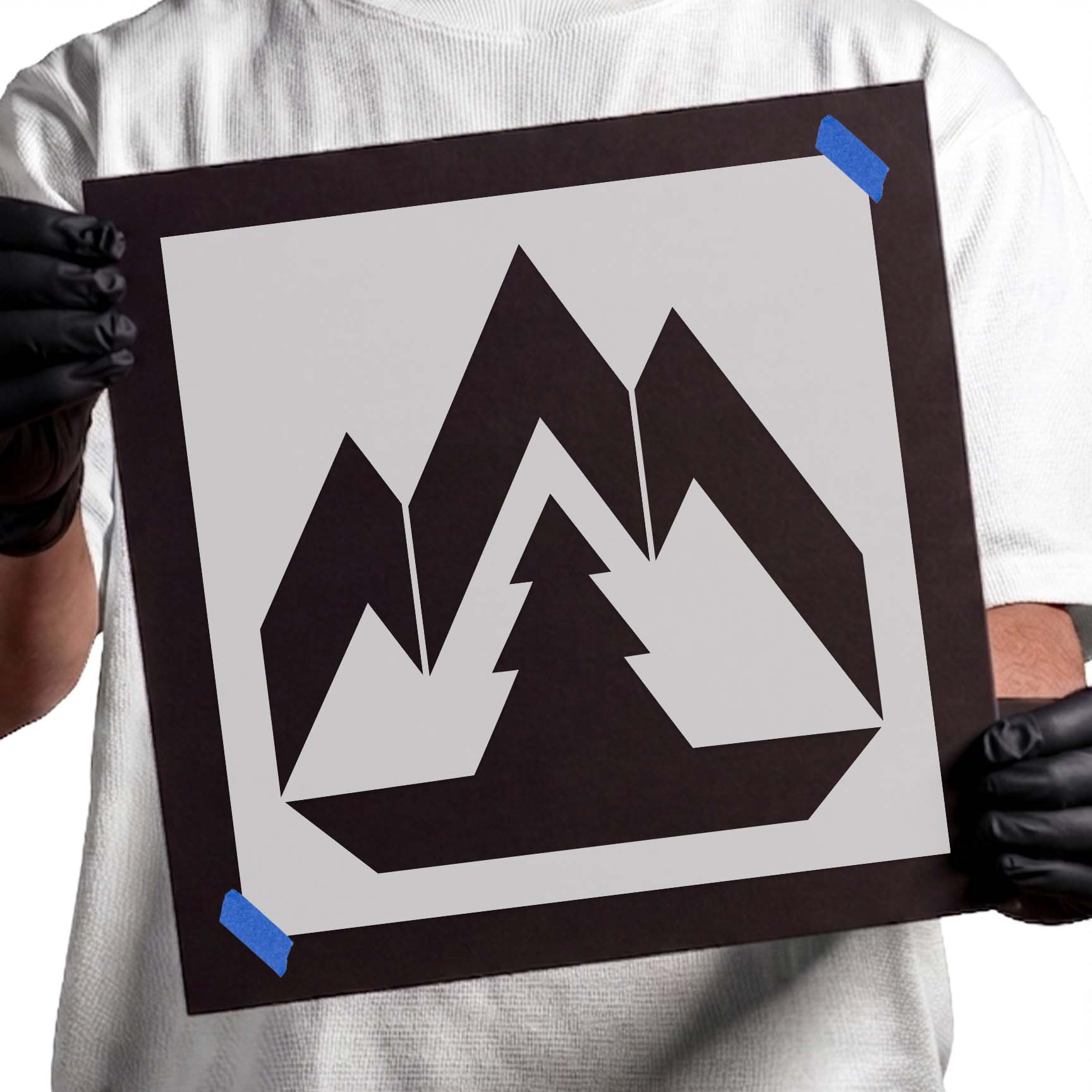 Geometric mountain range stencil with central evergreen tree