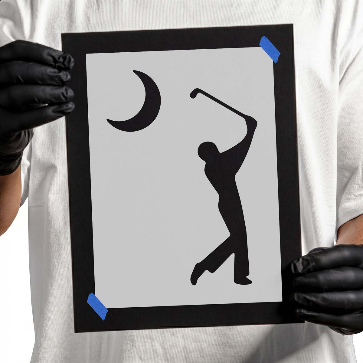 Golfer stencil silhouette swinging beneath a crescent moon