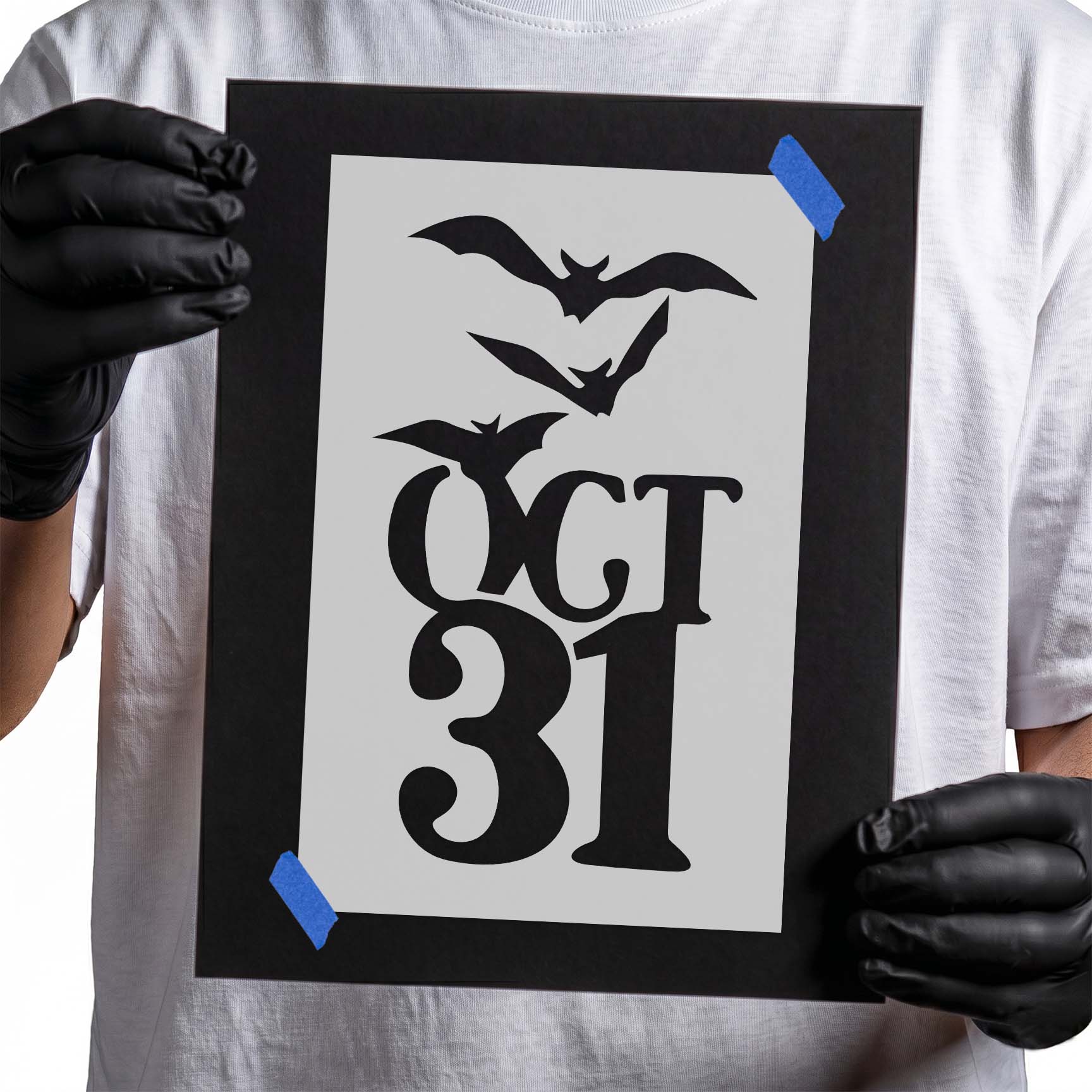 Person holding laser-cut Halloween Date with Bats Stencil