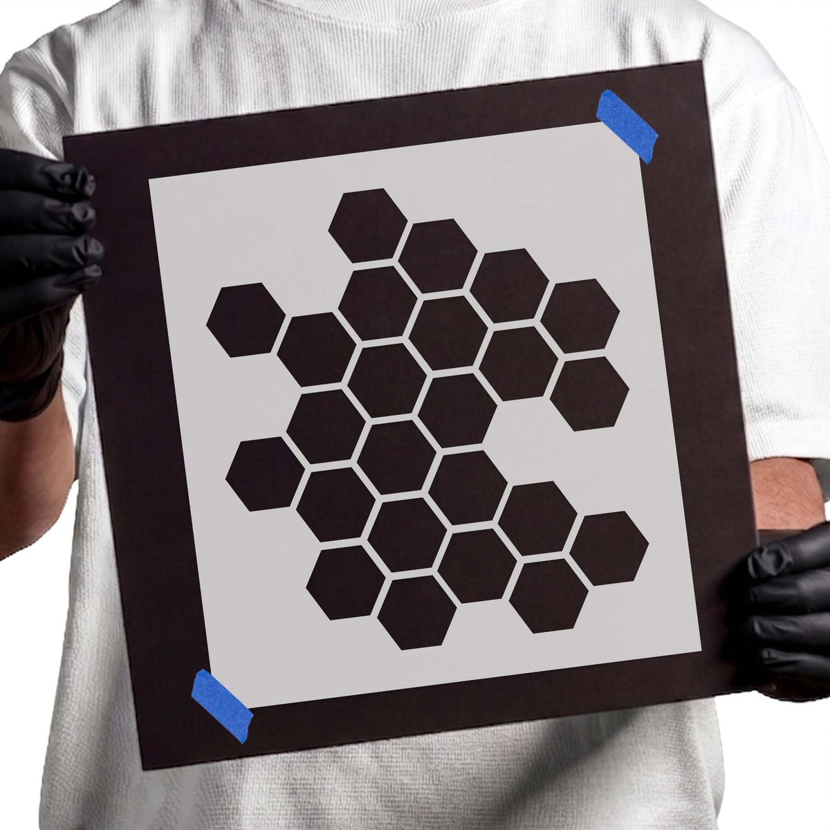 Honeycomb stencil featuring irregular clusters of hexagonal shapes with clean geometric edges.