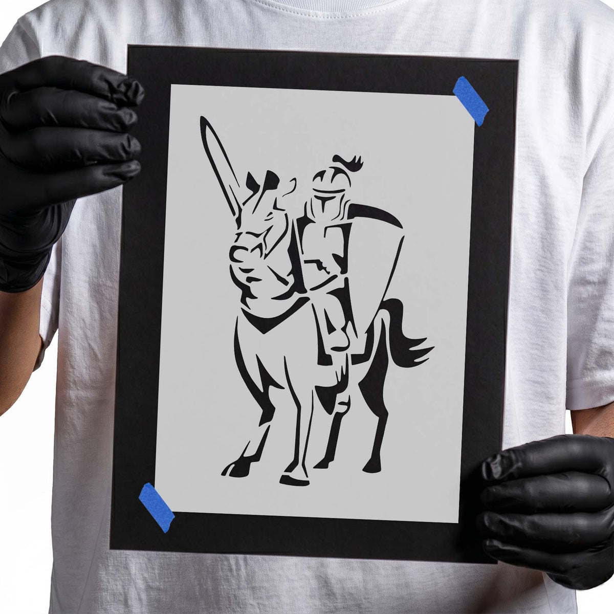 Medieval knight stencil riding horse with raised sword and shield