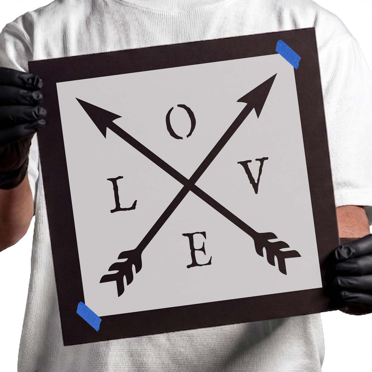 Love lettering stencil with two bold crossed decorative arrows