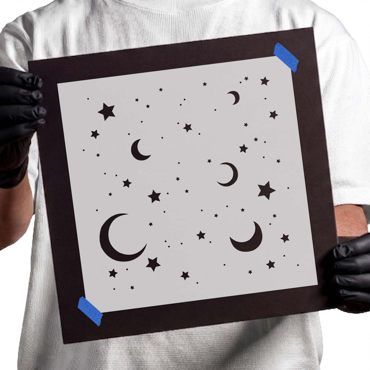 Stencil pattern with crescent moons, stars, and scattered celestial dots