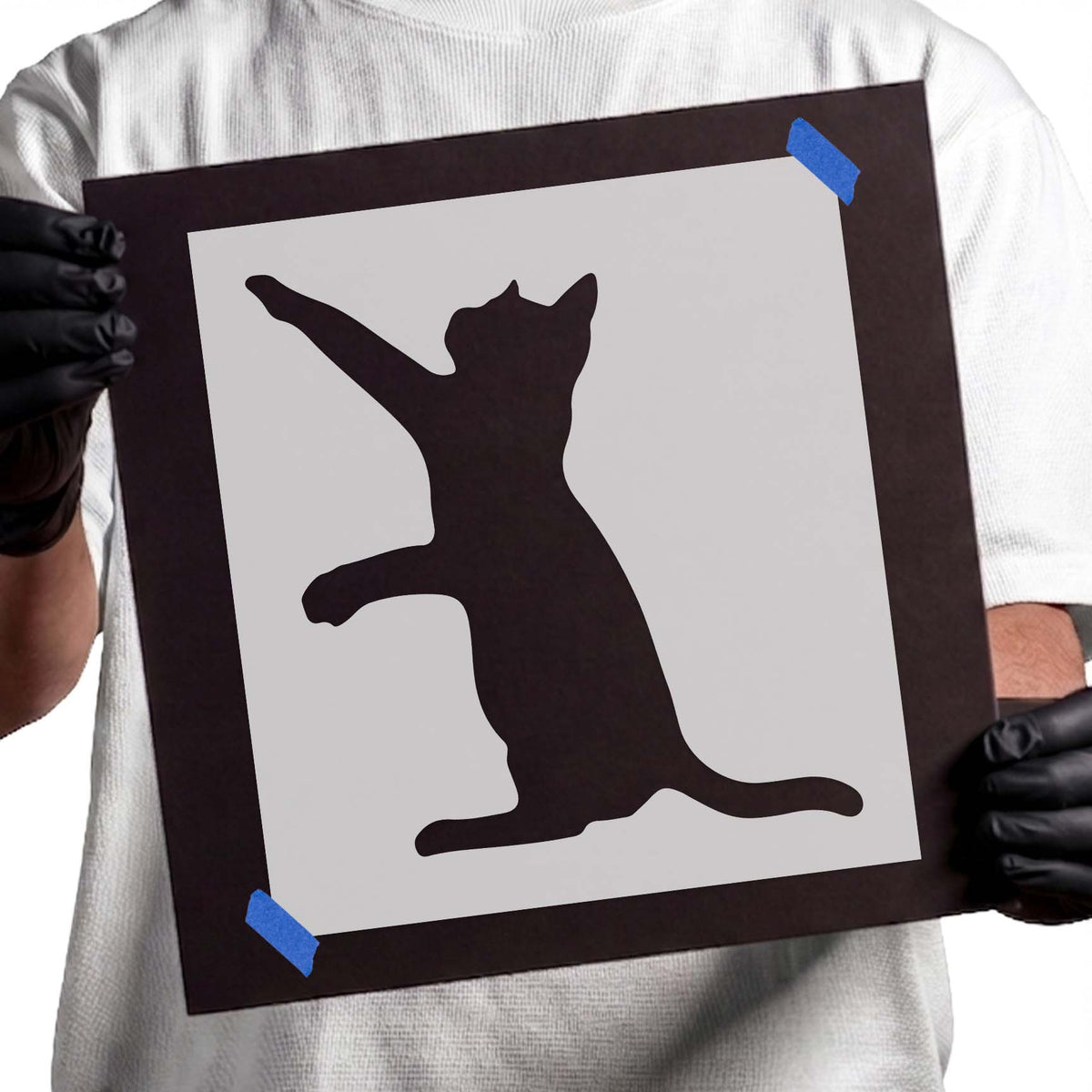 Playful cat stencil silhouette reaching upward with a long curved tail