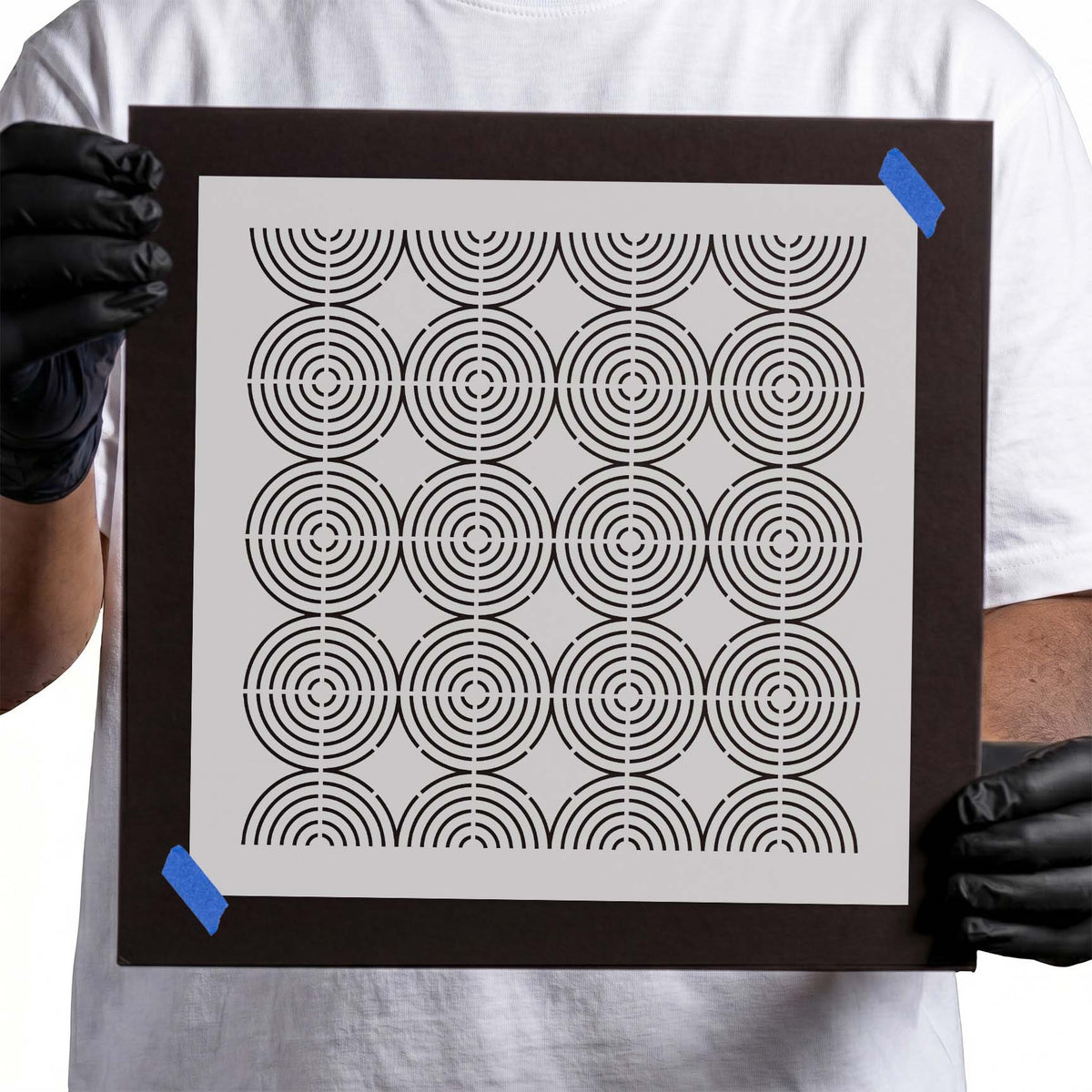 Stencil with repeating concentric circles arranged in a geometric grid