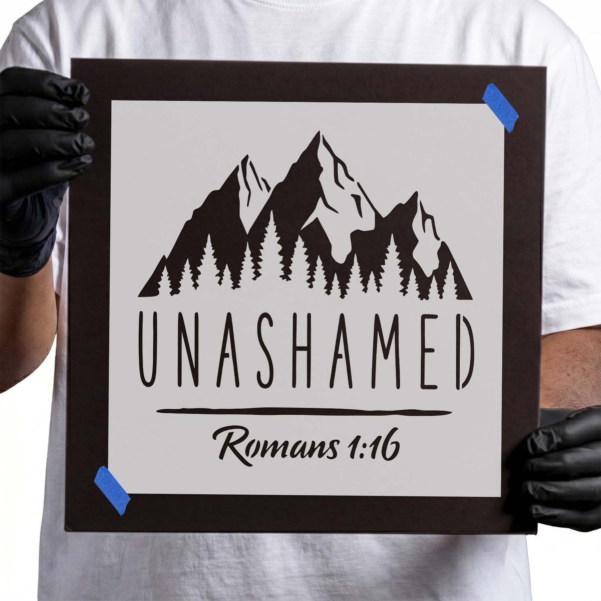 Romans 1:16 stencil with Unashamed lettering, mountains, and pine trees