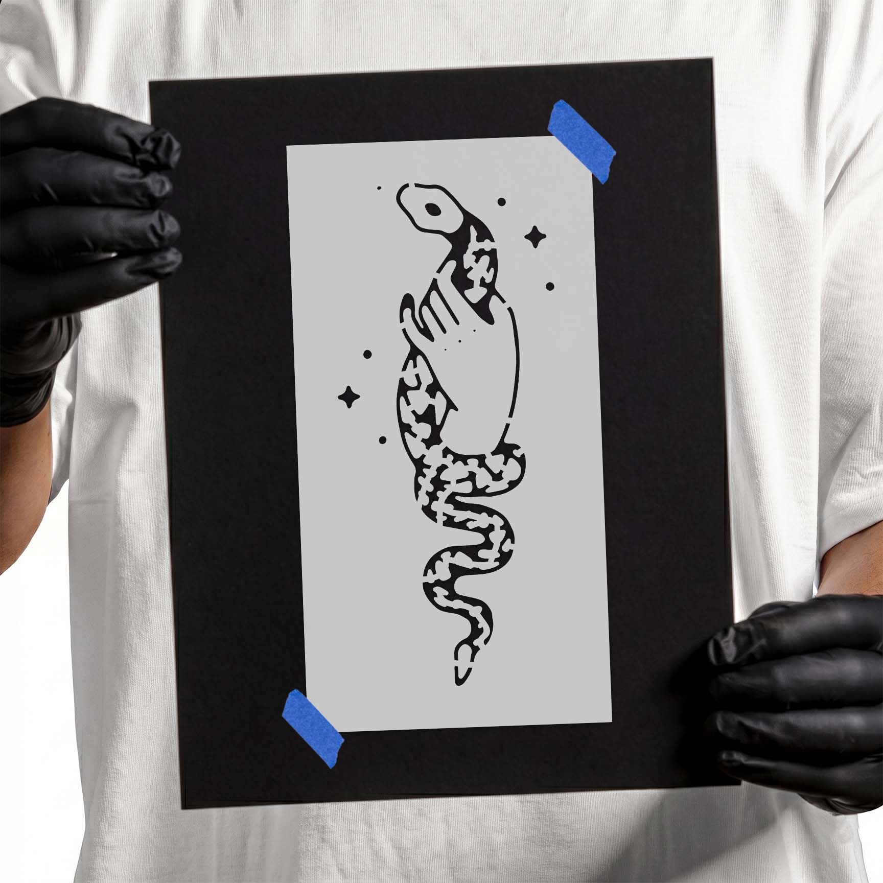 Person holding a reusable Snake in Hand Stencil