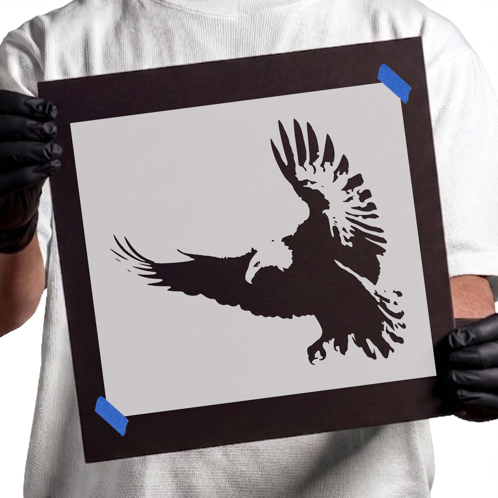 Flying vulture stencil with spread wings, detailed feathers, and lowered talons