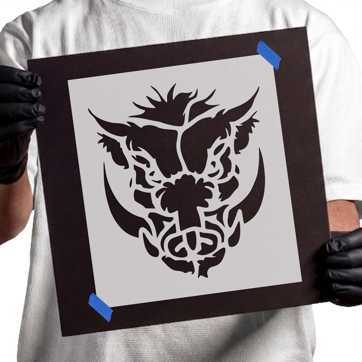 Warthog head stencil with curved tusks and rugged facial details
