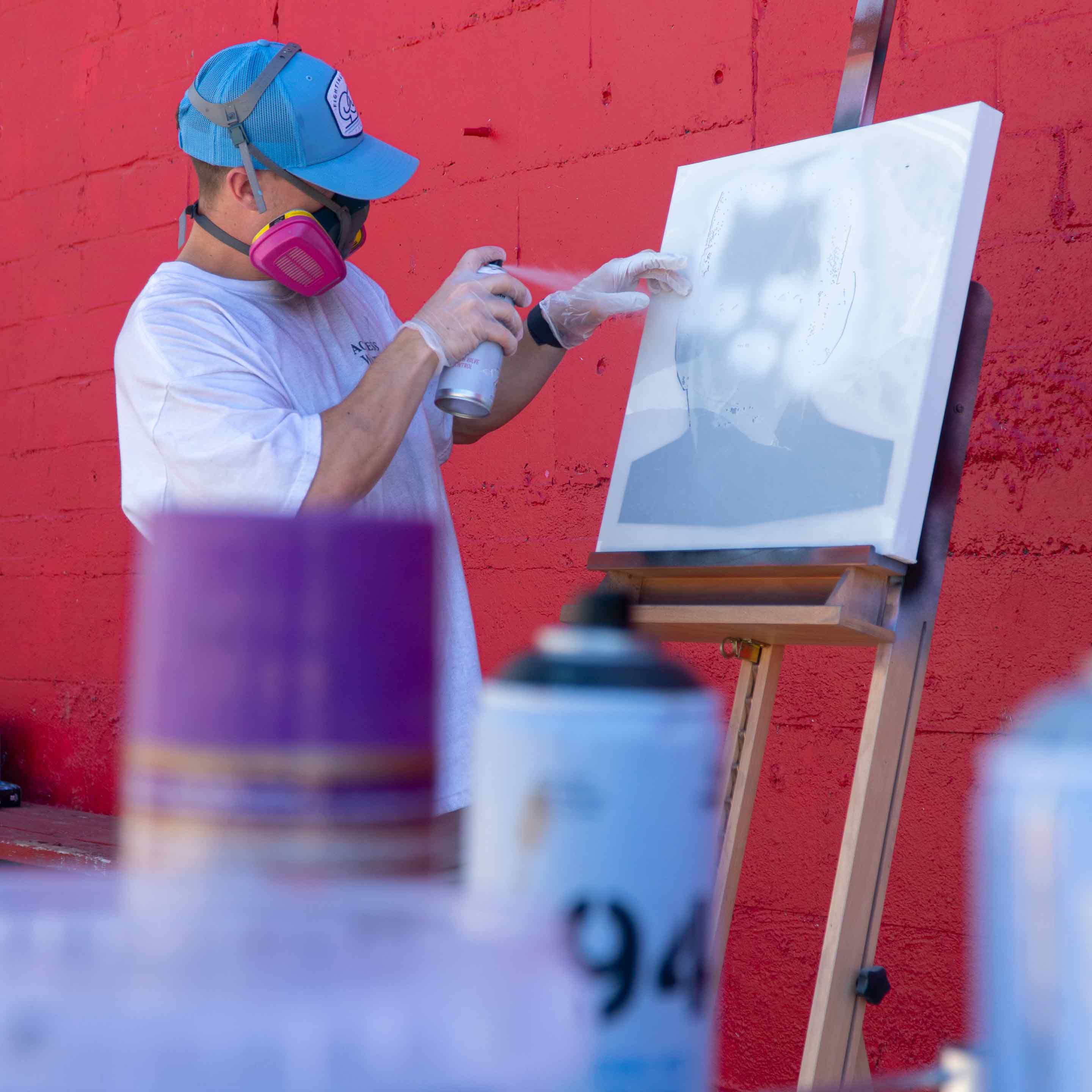 Custom layered stencil being spray painted