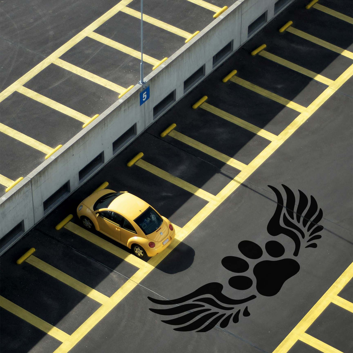 Angel Wings Paw Print Memorial Stencil makes a striking black tribute across parking lot pavement