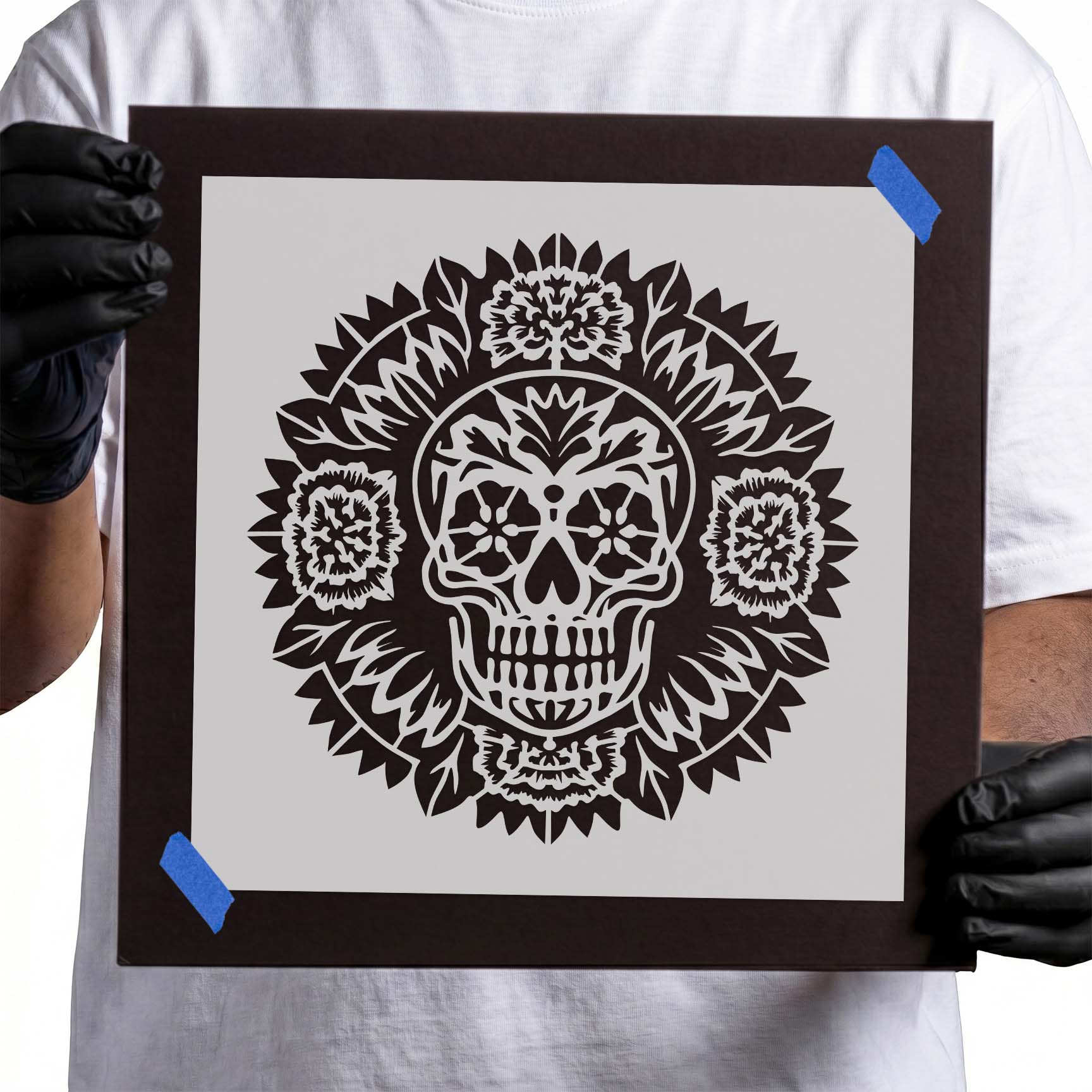 Sugar skull surrounded by an ornate floral mandala stencil design
