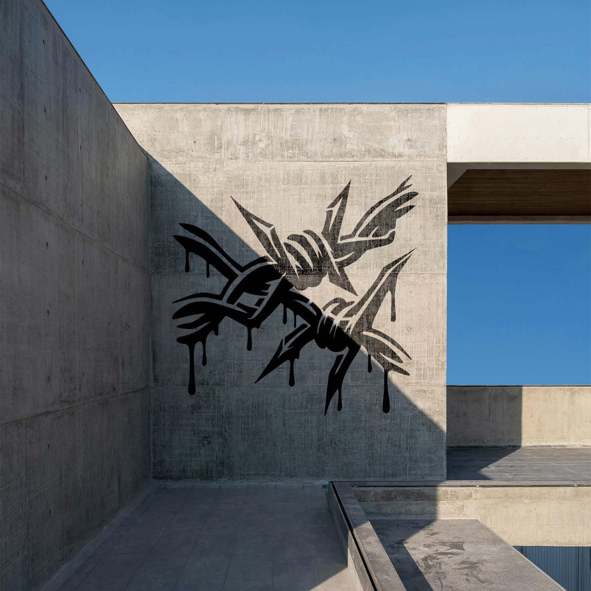 Black dripping barbs give the Dripping Barbed Wire Graffiti Stencil an edgy look on a modern concrete wall.