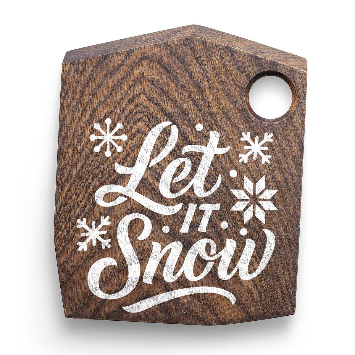 Festive Let It Snow Text Stencil adds snowy script and snowflakes to a rustic wooden cutting board.